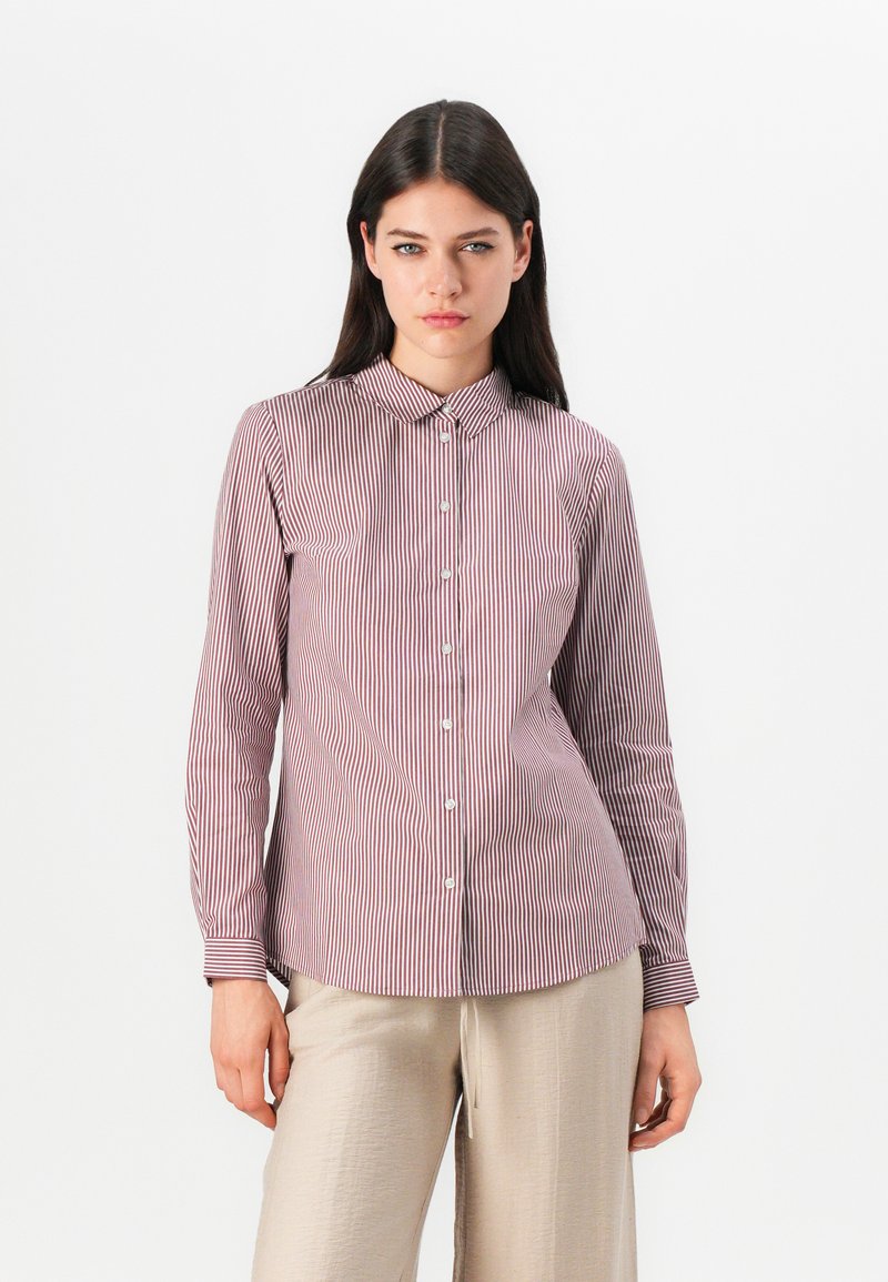 Long-sleeve shirt with a button-down collar, featuring thin vertical red and white stripes, and a fitted silhouette.