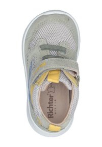 Light gray athletic shoe with mesh paneling, velcro strap, yellow and blue accents, and textured suede details. White rubber sole.