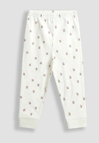 Biele detské nohavice s elastickým pásom a malým ružovým a zeleným kvetinovým vzorom po celej ploche.