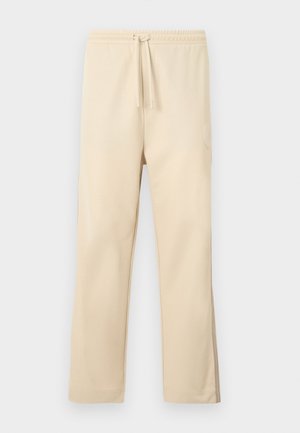 Μπεζ φόρμα από απαλό ύφασμα, με ελαστική μέση και κορδόνι, ίσια πόδια και λεπτομέρεια με πλαϊνή τσέπη.