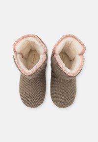 Knitted taupe slippers with a soft, cream lining, featuring a light pink trim along the top edge and textured rope detailing.