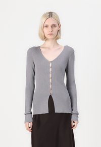 Gray ribbed knit cardigan with long sleeves, V-neck, button front closure, and a high slit at the hem. Smooth texture and fitted design.