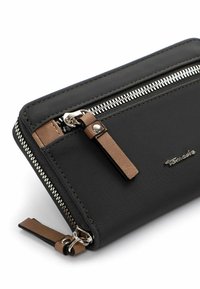 Black nylon wallet with silver zipper, brown leather accents, and a logo. Features a zip closure and a sleek, rectangular shape.