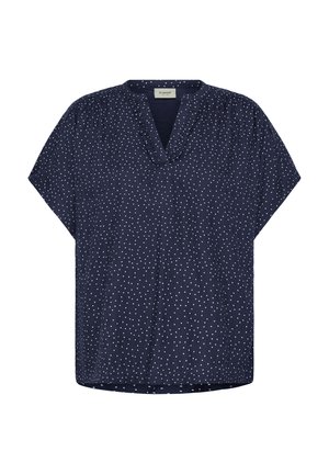 Blouse à manches courtes bleu marine à pois blancs, encolure en V avec un léger volant et coupe ample.