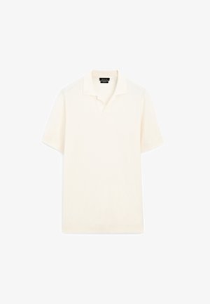 Polo-shirt i off-white, med korte ærmer, et tekstureret stof og et traditionelt kravedesign. Søm uden samlinger og minimal detaljer.