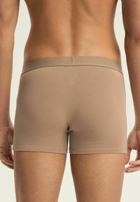 Beżowe bawełniane bokserki stretch, z miękkim pasem, dopasowanym krojem i gładką teksturą, z minimalnym widocznym logo z tyłu.