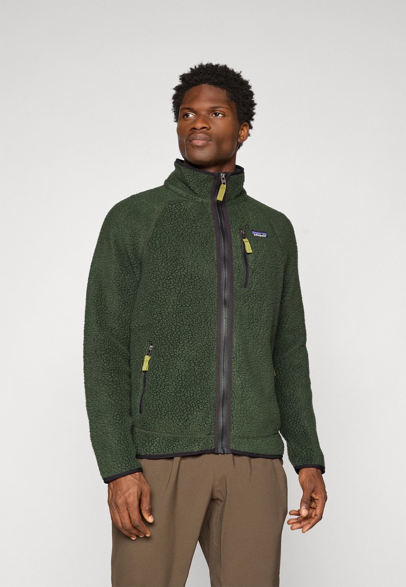 Fleece jacket in dark green with a textured finish, high collar, front zipper, and two zippered side pockets with contrasting zipper pulls.