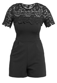Svart romperskjort med en åtsittande bodice och ett spetsöverdrag på de korta ärmarna, med blommönster och en rundad halsringning.
