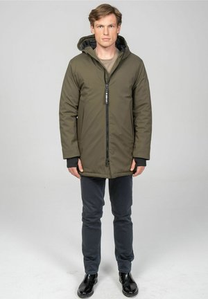 Olive-green parka with a front zipper, hood, and black accents. Polyester material, straight cut, and large side pockets.
