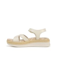Light beige espadrille sandals with cross straps, a textured sole, and a braided jute midsole. Smooth leather upper, flat rubber outsole.