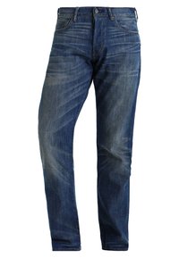 Jeans de mezclilla azul oscuro, corte recto, con un lavado deslavado. Cuenta con cinco bolsillos, trabillas para cinturón y cierre de cremallera.