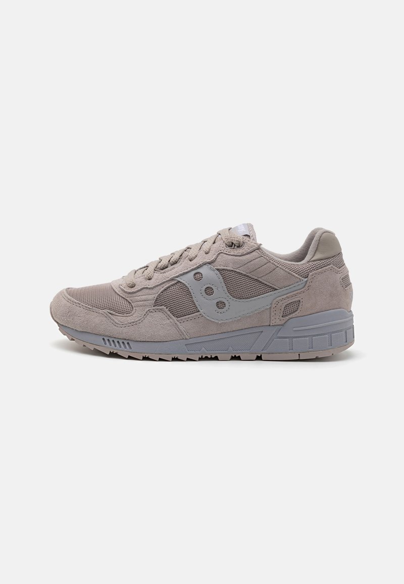 Light gray sneaker with a combination of textured suede and mesh upper, featuring a gray logo accent, flat laces, and a rubber sole.