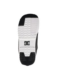 Schwarzer Sneaker mit einer weißen und strukturierten Sohle, die ein DC-Logo trägt. Die Sohle hat ein gemustertes Profil für Grip und Stabilität.