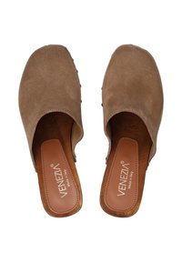 Brown suede clogs with open backs, wooden insoles, and embossed brand logo. Smooth texture and rounded toes. No visible hardware.