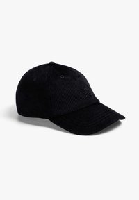 Gorra de béisbol de pana negra con una corona redondeada, visera curva y logo de calavera bordado en la parte frontal. Textura suave y diseño casual.