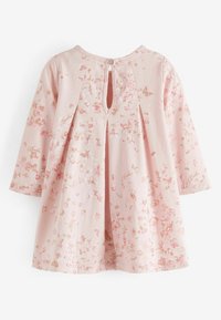 Vaaleanpunainen pitkähihainen vauvan mekko, jossa on kukka- ja perhoskuvio, laskokset takana ja nappikiinnitys kaula-aukon kohdalla.