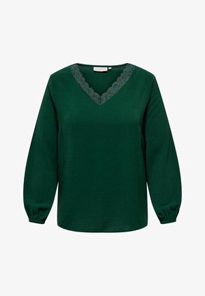 Roheline pluus pikkade varrukatega, V-kaelusega ja pitsist äärisega kaeluses. Tekstureeritud kangas ja elastsed mansetid lisavad detaili.