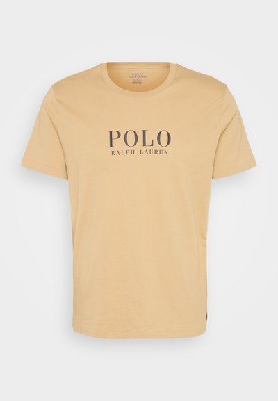 Rövid ujjú, kerek nyakú póló puha sárga pamutból, középen sötét betűkkel a "POLO RALPH LAUREN" logóval.