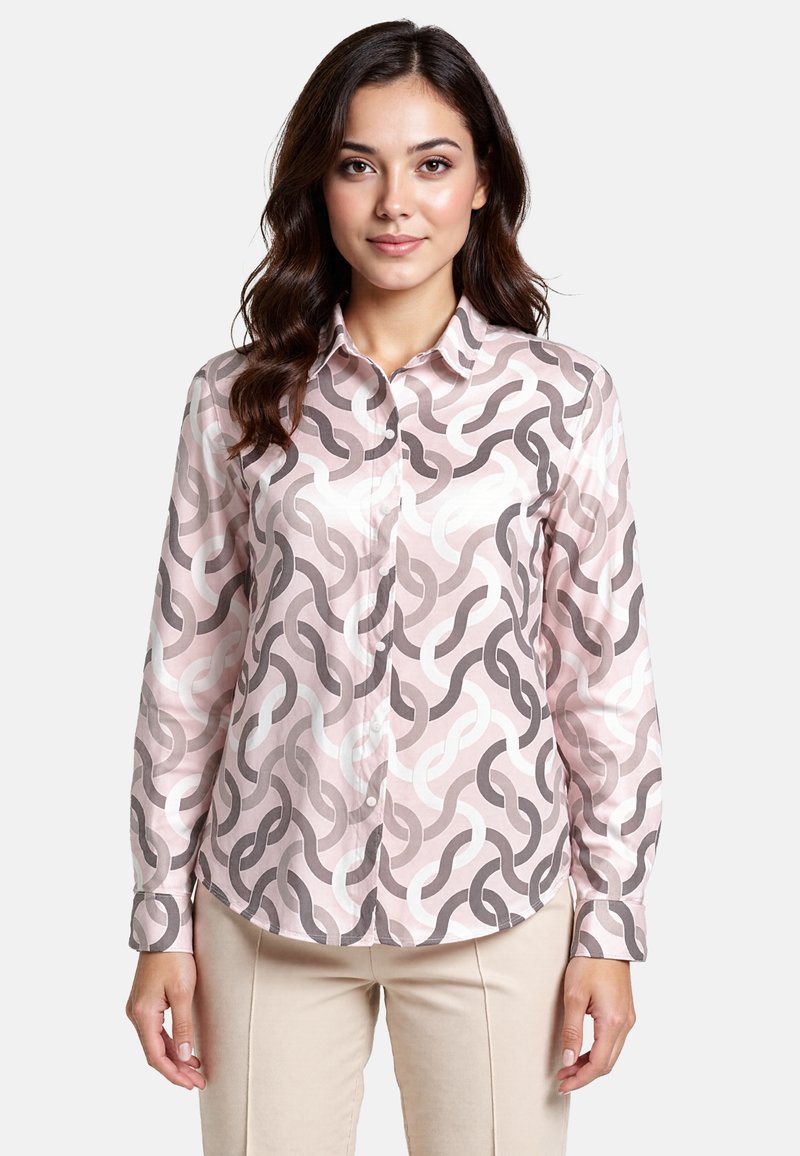 Long-sleeve button-up shirt in pastel pink featuring an abstract chain pattern in dark gray and white. Soft fabric with collar and cuffs.