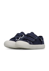 Navy canvas shoes with two Velcro straps, white rubber soles, and textured detailing on the toe cap and heel. Rounded shape, casual design.