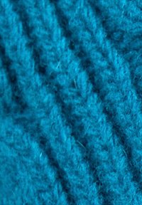 Turquoise knitted fabric, featuring a soft texture with a ribbed pattern and varying thickness, is closely woven with visible fibers.