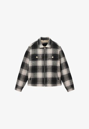 Schwarz-weißer kariertes Zip-Hoodie mit Kragen, zwei betriebelten Brusttaschen und seitlichen Handtaschen, flach auf einem weißen Hintergrund ausgelegt.