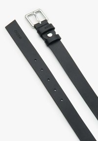 Černý kožený opasek se stříbrnou sponou, s hladkým povrchem, nastavovacími otvory a vyrytým logem poblíž spony.
