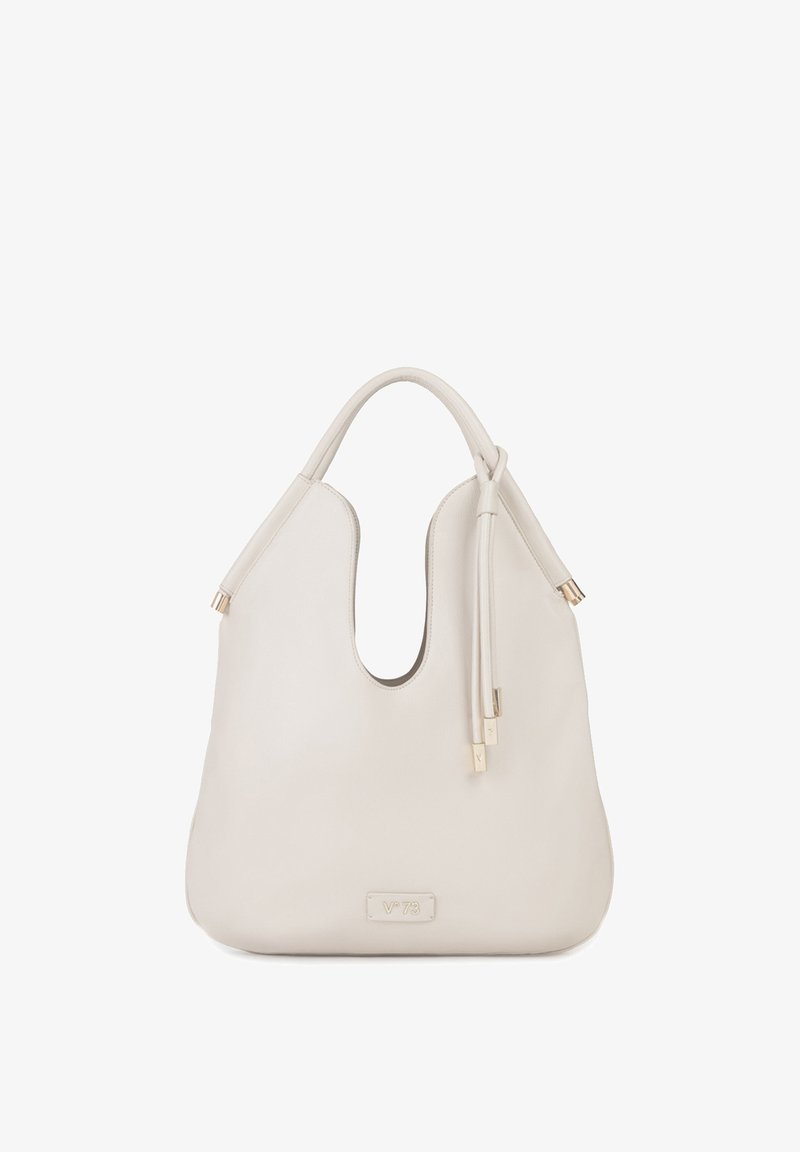 Crèmekleurige leren handtas met een enkele handgreep, een gebogen bovenopening en decoratieve tassels aan één zijde.