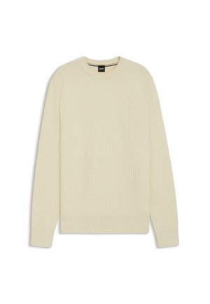 Light beige sweater with a textured waffle knit design, crew neck, and ribbed cuffs and hem. Simple, modern shape with no additional accents.