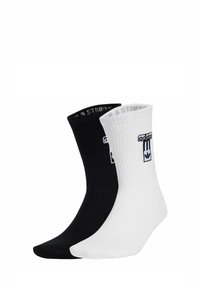 Cotton blend socks in black and white, ribbed design, featuring logo accents on the cuff, with contrasting color toes and heels.