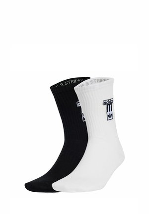 Cotton blend socks in black and white, ribbed design, featuring logo accents on the cuff, with contrasting color toes and heels.
