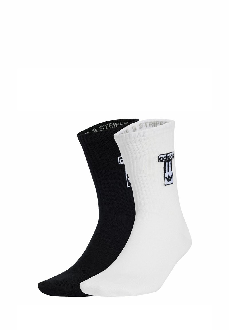 Cotton blend socks in black and white, ribbed design, featuring logo accents on the cuff, with contrasting color toes and heels.