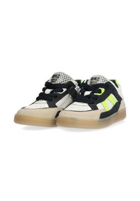 Low-top sneakers with a white and black upper, suede accents, fluorescent lime green details, and a translucent rubber sole.