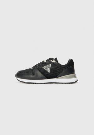 Black sneaker with mesh and leather material, featuring a triangular logo, contrasting white sole, and lace closure with reinforced eyelets.