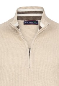 Beige knit pullover with a half zipper, ribbed collar featuring brown and white stripes, and a textured weave pattern. Brand tag visible.