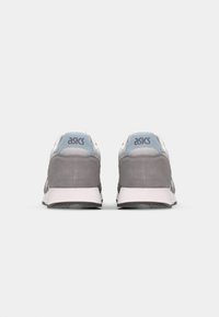 Gray suede sneakers with light blue and white accents, featuring a padded collar, logo on the heel, and a textured rubber sole.