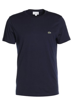T-shirt Lacoste bleu marine à manches courtes, col rond et petit logo crocodile vert sur le côté gauche de la poitrine.
