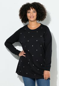 Tunika nera a maniche lunghe con decorazioni argentate sparse sul tessuto, con scollatura tonda e spacchi laterali.