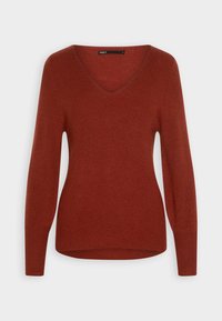 Maglione color ruggine realizzato in morbido tessuto a coste. Caratterizzato da un colletto a V, maniche lunghe e un orlo leggermente curvo nella parte inferiore.