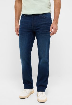 Dark blue denim jeans with a straight cut, featuring a classic five-pocket design. Worn with white sneakers, showing a casual fit.
