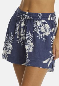 Granatowe szorty w kwiatowy wzór z elastycznym paskiem, z wyraźnymi jasnymi tropikalnymi kwiatami i liśćmi na teksturowanym materiale.