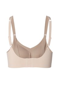 Beige trådlös bh med justerbara remmar, V-formad rygg och hakstängning. Tillverkad av mjukt tyg med en sömlös design.