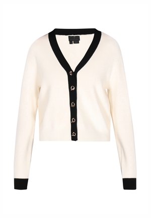 Kremowy krótki kardigan z czarnym dekoltem w serek i czarnymi mankietami, z kontrastującymi złotymi guzikami z przodu. Miękka tekstura.