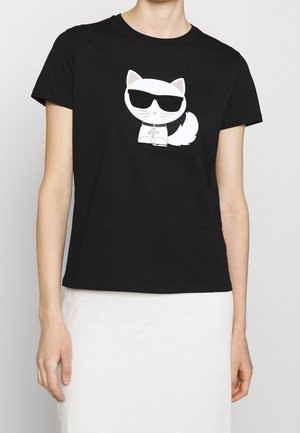 Black cotton T-shirt featuring a white cartoon cat with sunglasses printed on the front. Short sleeves and a relaxed fit.
