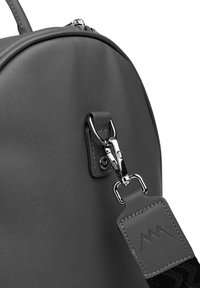 Gray leather backpack with a rounded shape, silver hardware, and a textured strap featuring a logo. Zipper closure visible on top.