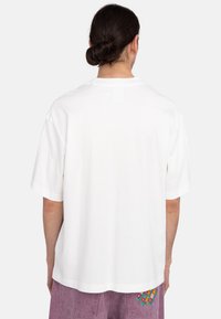 White cotton T-shirt with short sleeves, relaxed fit, and a crew neckline. No visible designs or patterns on the back.