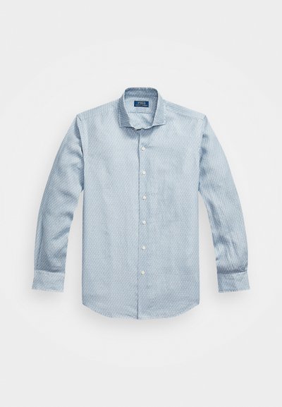 Chemise boutonnière bleu clair avec un motif texturé, manches longues et col classique. Boutons blancs et ourlet arrondi. Fabriquée en tissu mélangé de coton.