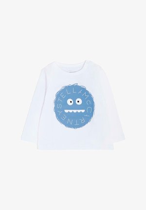 Biała koszula z długim rękawem z okrągłym niebieskim wzorem przedstawiającym wesołą twarz potwora oraz napisem "STELLA McCARTNEY" w białych akcentach.
