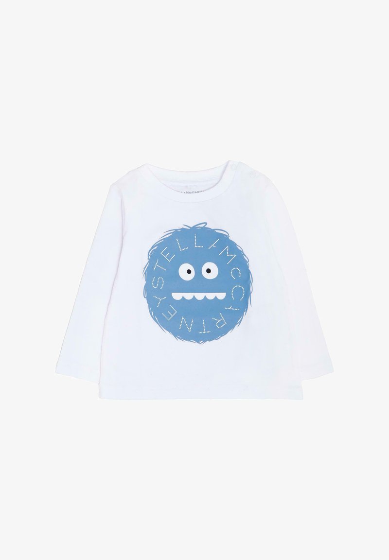 Chemise à manches longues blanche avec un graphique rond bleu représentant un visage de monstre ludique et le texte "STELLA McCARTNEY" en accents blancs.