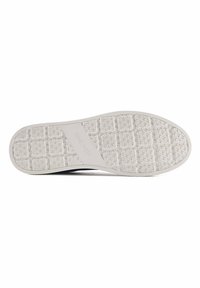 White sneaker outsole with textured grip pattern, featuring a central grey accent labeled "NINE WEST," made from flexible rubber material.